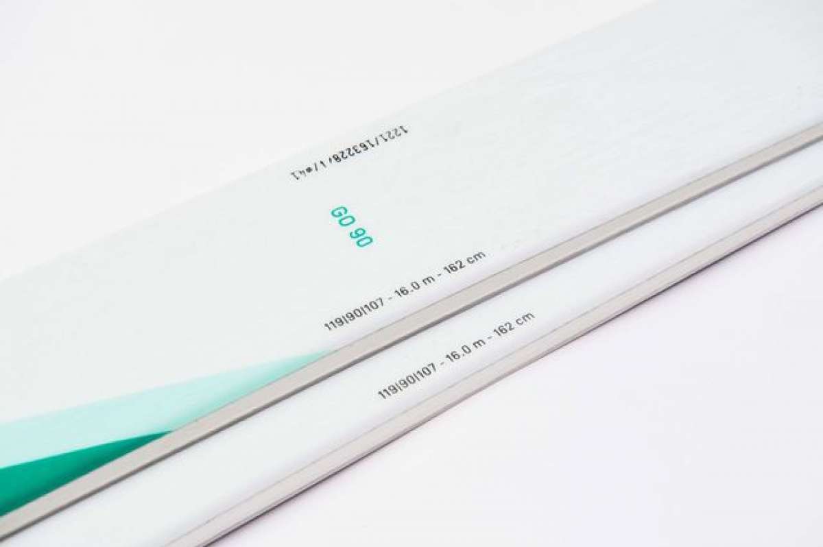 Movement Women's GO 90 Skis - White skis with black lettering and a green logo on top.