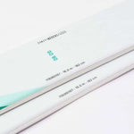 Movement Women's GO 90 Skis - White skis with black lettering and a green logo on top.