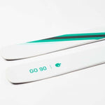Movement Women's GO 90 Skis 2024 - White skis with green stripe on top.