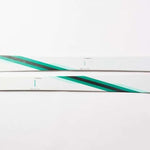Movement Women's GO 90 Skis 2024 - White skis with a diagonal teal stripe on top.