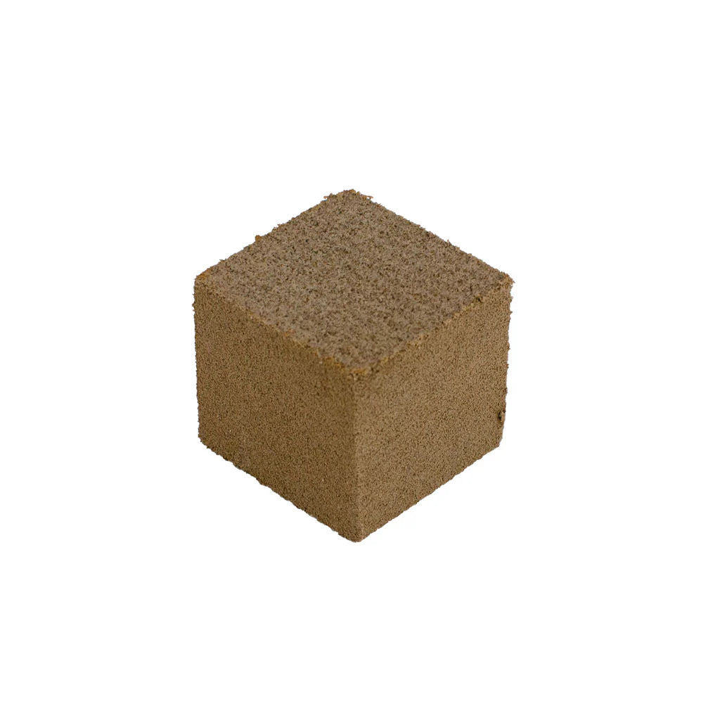 Oneball Gummy Stone 2025 - A brown, cube-shaped stone with a rough texture and small holes on its surface.