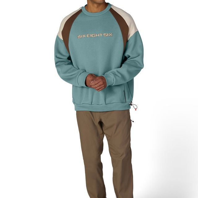 Colorblocked crewneck sweatshirt in teal with brown shoulder panels and chest logo