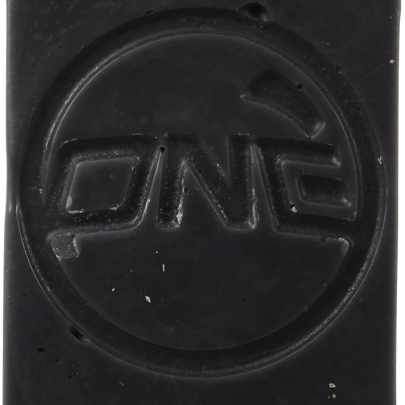 Oneball X-Wax Cold 21 - 5F 2025 - A rectangular, black wax block with illegible white text on its top surface.