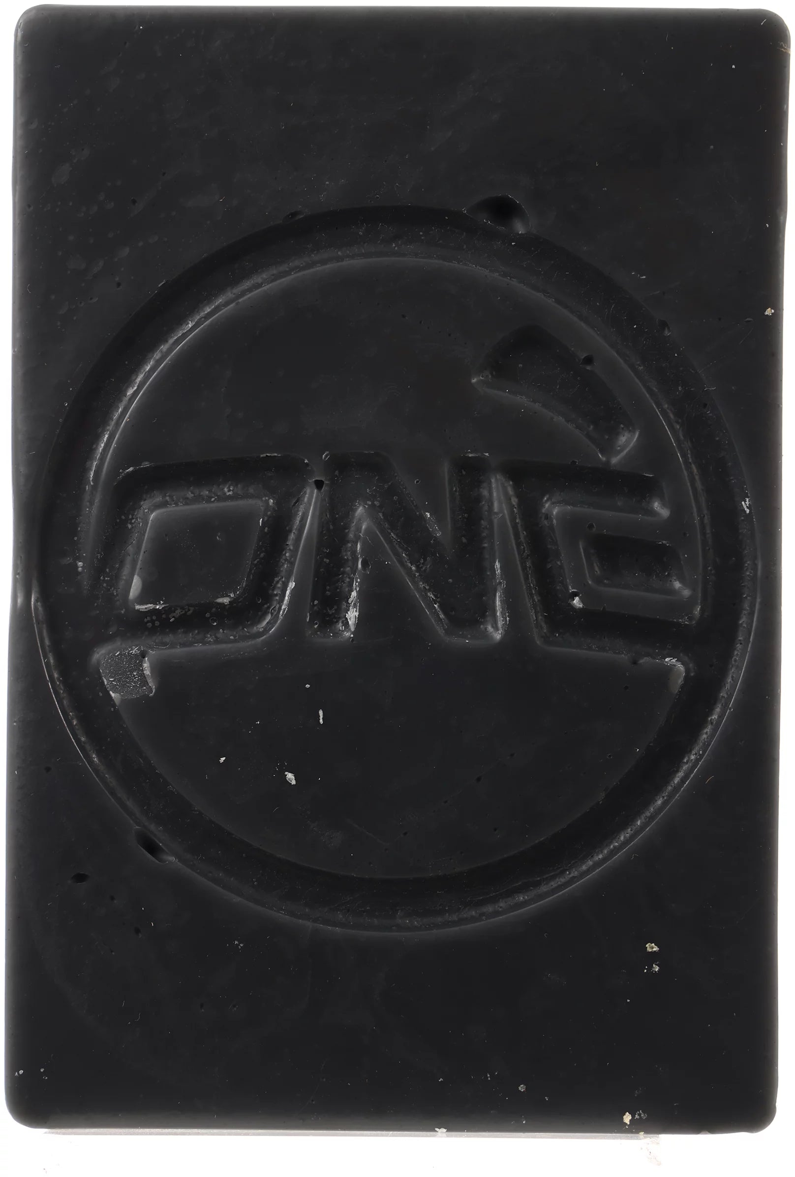 Oneball X-Wax Cold 21 - 5F 2025 - A rectangular, black wax block with illegible white text on its top surface.