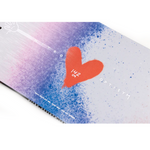 Nitro Women's Optisym Snowboard 2026 - A snowboard with a purple and pink gradient background, featuring a large red heart in the center.