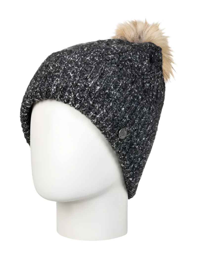 Roxy Women's Peak Chic Beanie 2025 - A black beanie with a white speckled pattern and a tan faux fur pom-pom on top.