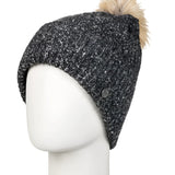 Roxy Women's Peak Chic Beanie 2025 - A black beanie with a white speckled pattern and a tan faux fur pom-pom on top.