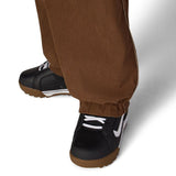 Brown shell pants with elastic ankle cuff and relaxed tapered leg