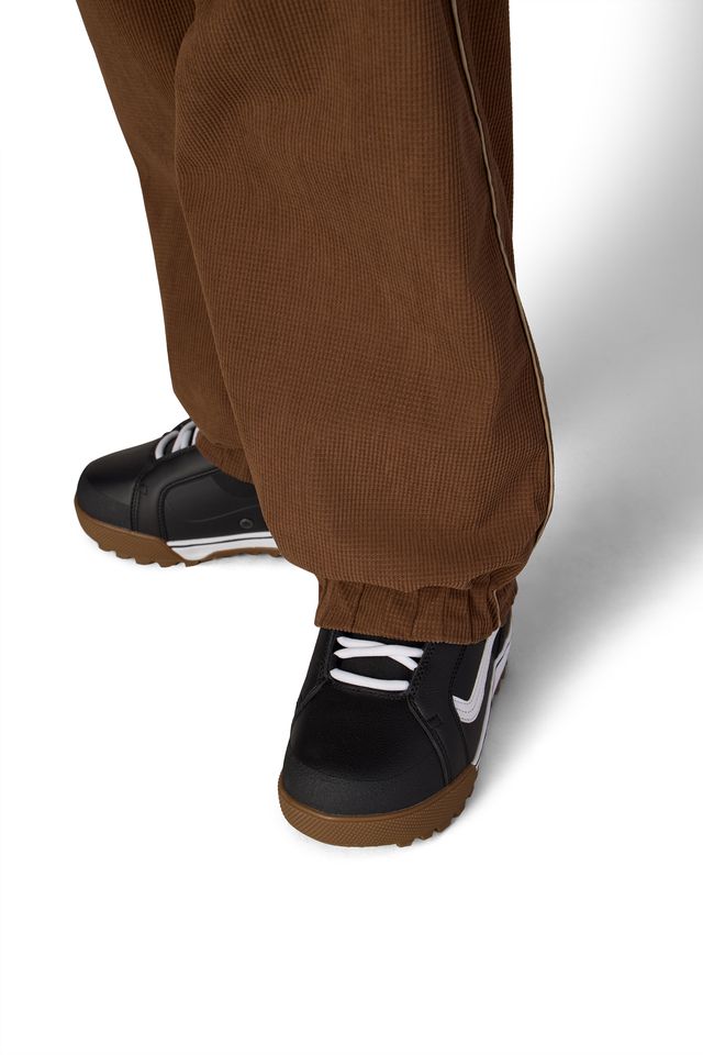 Brown shell pants with elastic ankle cuff and relaxed tapered leg