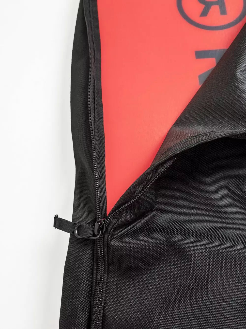Ride Unforgiven Sleeve Snowboard Bag - A black snowboard bag with a zipper and handle, featuring a red interior lining.