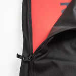Ride Unforgiven Sleeve Snowboard Bag - A black snowboard bag with a zipper and handle, featuring a red interior lining.