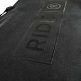 Ride Unforgiven Sleeve Snowboard Bag 2025 - Black snowboard bag with a white logo on top and black straps.