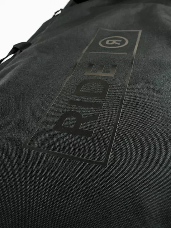 Ride Unforgiven Sleeve Snowboard Bag 2025 - Black snowboard bag with a white logo on top and black straps.