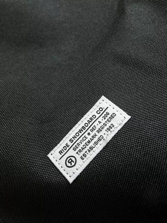 Ride Unforgiven Sleeve Snowboard Bag 2025 - Black snowboard bag with a white logo on the front and black straps.