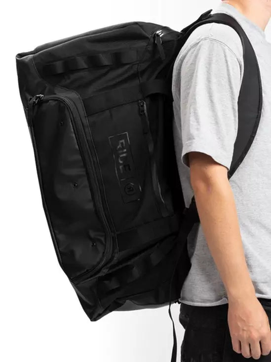 Ride Duffle Bag 2025 - Black duffel bag with zippered pockets and handle on top.