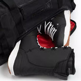 Ride Duffle Bag 2025 - Black duffel bag with zippered pocket on front and black handle.