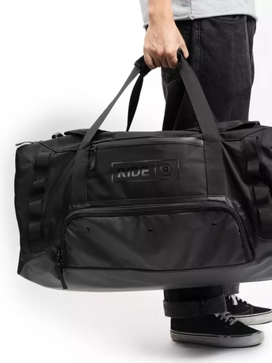 Ride Duffle Bag - Black duffel bag with zippered pockets on front.