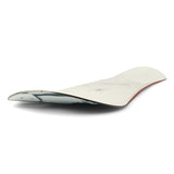 Ride Women's Compact Snowboard 2025 - A white snowboard with black and gray abstract design on top, featuring a red stripe along the bottom edge.