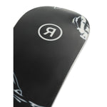 Ride Women's Magic Stick Snowboard 2025 - A black snowboard with a white logo featuring a stylized "R" in a circle, and a white graphic of a woman riding on the top right corner.