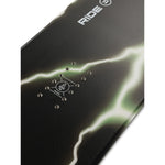 Ride Superpig Snowboard 2025 - A black snowboard with a green and white abstract design on its top surface.