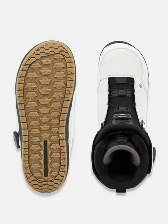Snowboard boots with treaded outsole and black strap closure, boot opening view