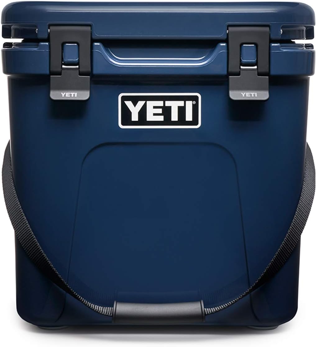 Yeti Roadie 24 Hard Cooler - A navy blue cooler with a handle on top and two latches on the front.