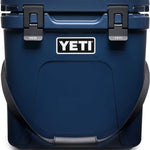 Yeti Roadie 24 Hard Cooler - A navy blue cooler with a handle on top and two latches on the front.
