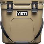 Yeti Roadie 24 Hard Cooler - A tan cooler with a handle on top and two latches on either side of it.