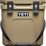 Yeti Roadie 24 Hard Cooler - A tan cooler with a handle on top and two latches on either side of it.