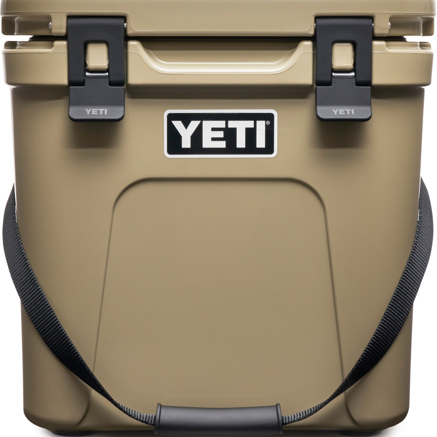 Yeti Roadie 24 Hard Cooler - A tan cooler with a handle on top and two latches on either side of it.