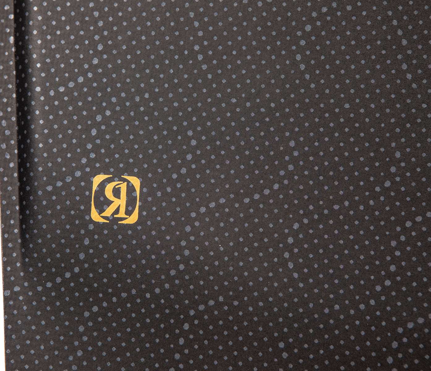 Ronix Ladies Rise Wakeboard 2024 - A black wakeboard with a white and grey patterned design on its top side.