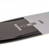 Ronix Supreme Wakeboard 2024 - A black wakeboard with a white logo and text on top, lying flat on its side.