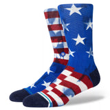 THE BANNER CREW C SOCK 2023 - Red, white, and blue crew socks with a large American flag design on top of them.