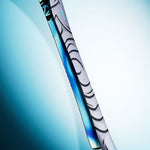 Salomon QST 100 Skis 2026 - White skis with black abstract design and blue accents on tips.