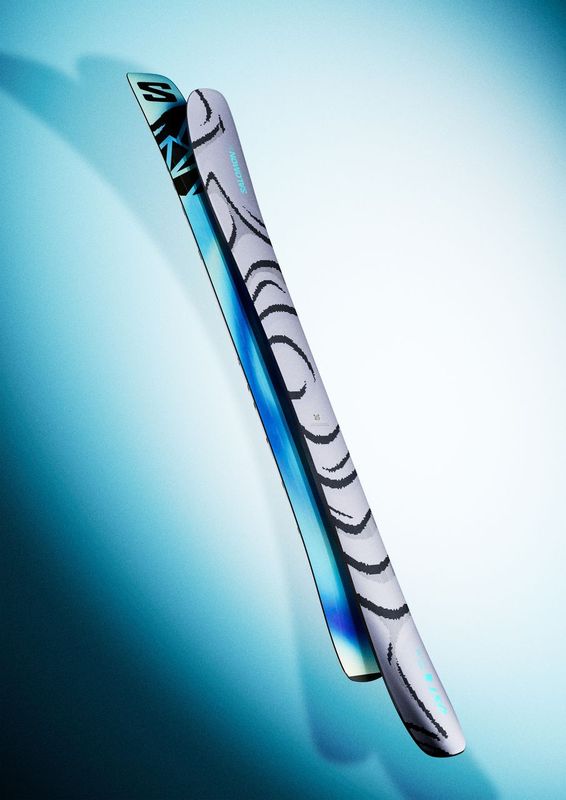 Salomon QST 100 Skis 2026 - White skis with black abstract design and blue accents on tips.