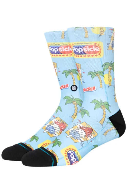 POPS CREW C SOCK 2024 - A pair of light blue crew socks with a repeating pattern of palm trees and popsicles.
