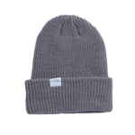 Coal Stanley Mid Length Beanie 2025 - A gray beanie with a white rectangular label on the front that reads "COAL" in black letters.