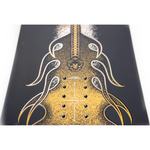 Nitro Stiletto RS x Drew Hicken Snowboard 2026 - A black snowboard with a yellow graphic of a woman's face and hair on top, and a yellow graphic of a man's face and mustache at the bottom.