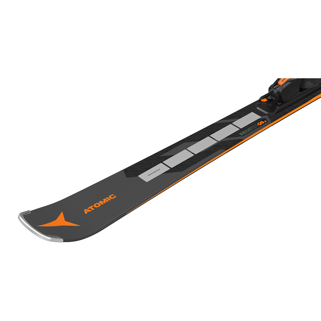 Atomic Redster Q9.8 Revoshock S with I12 Bindings - A black ski with orange accents and silver tips, featuring a distinctive "Revoshock" logo on the tip.