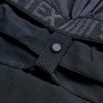 Women’s black cargo pants close-up: snap strap and reinforced fabric