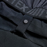Women’s black cargo pants close-up: snap strap and reinforced fabric