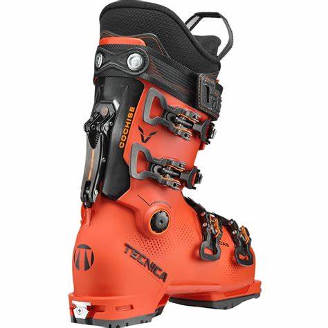 Tecnica Youth Cochise Jr Ski Boots 2025 - A pair of bright orange ski boots with black buckles and straps, featuring a textured pattern on the side.