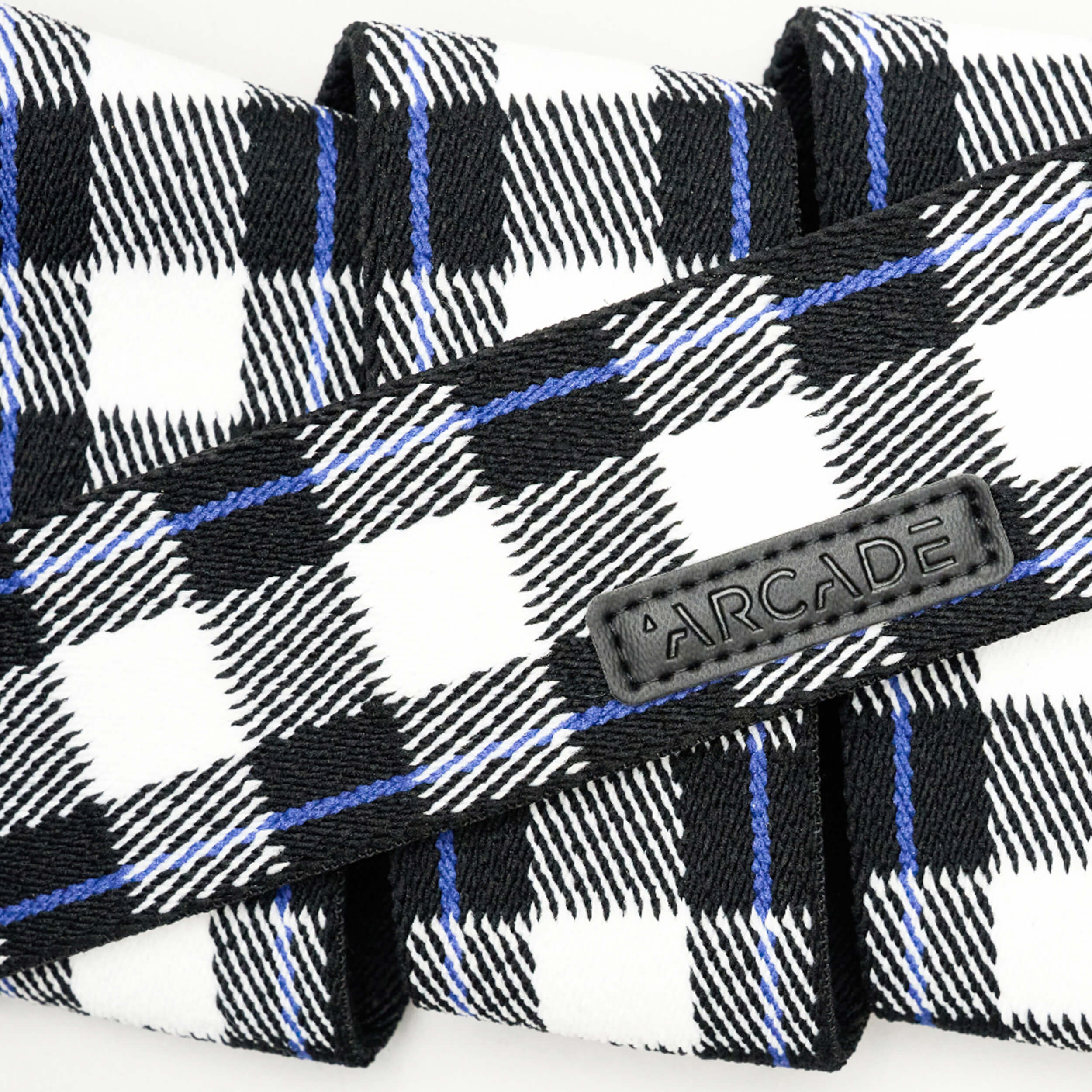 Arcade Plaid Stretch Belt 2025 - Black belt with blue, white, and black plaid pattern.
