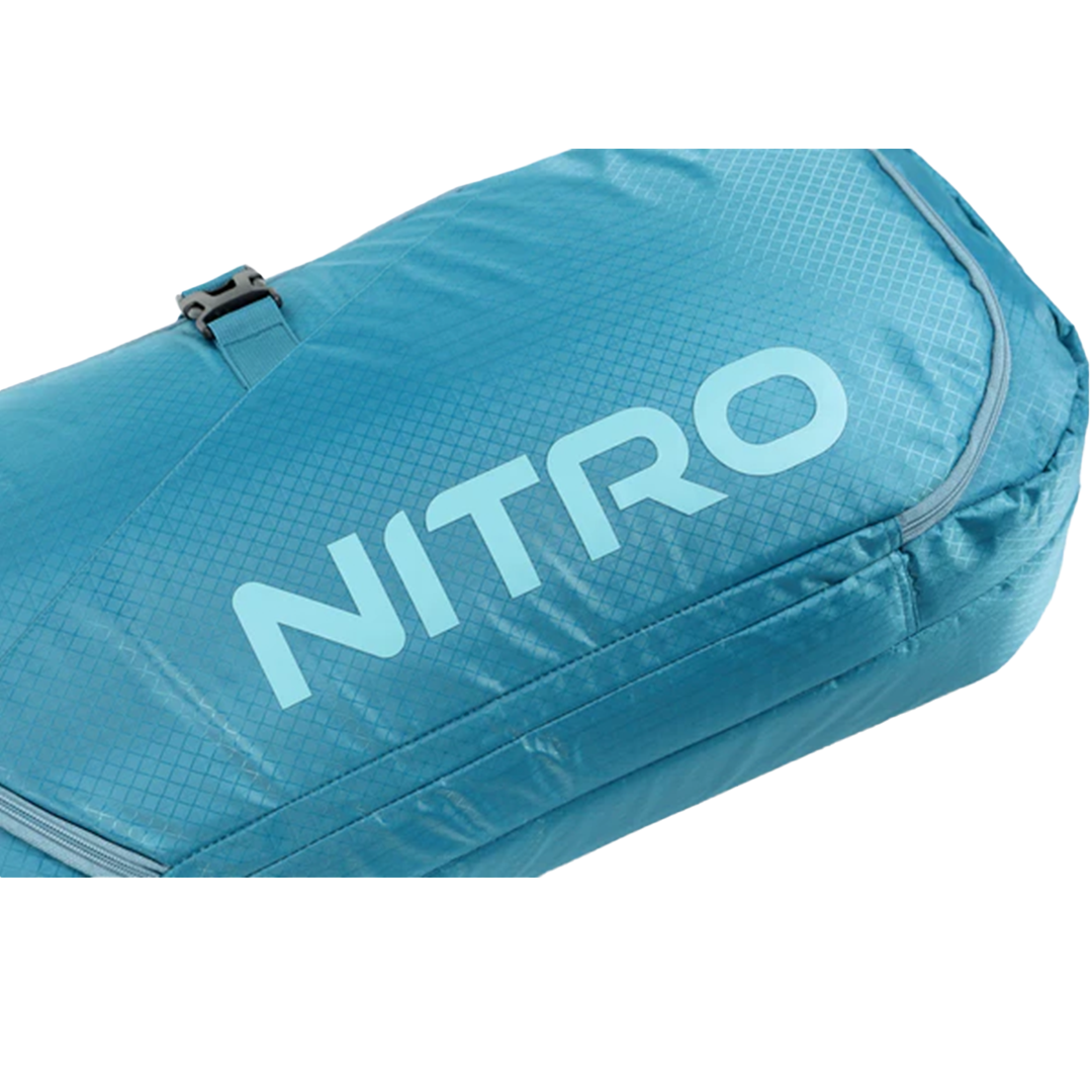 Nitro Tracker Wheelie Snowboard Bag - A light blue snowboard bag with a grid pattern and zipper on top, featuring the word "NITRO" in large letters across its side.