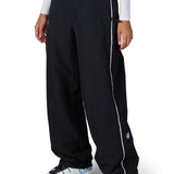 Black shell pants with elastic waistband, side piping, and cuffed hems