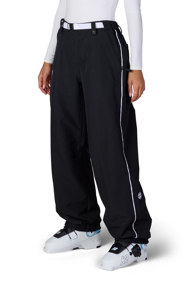 Black shell pants with elastic waistband, side piping, and cuffed hems