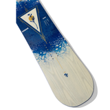 Arbor Women's Veda Snowboard 2026 - A blue snowboard with a white triangle logo featuring a plant design and yellow lines, set against a light wood grain background.