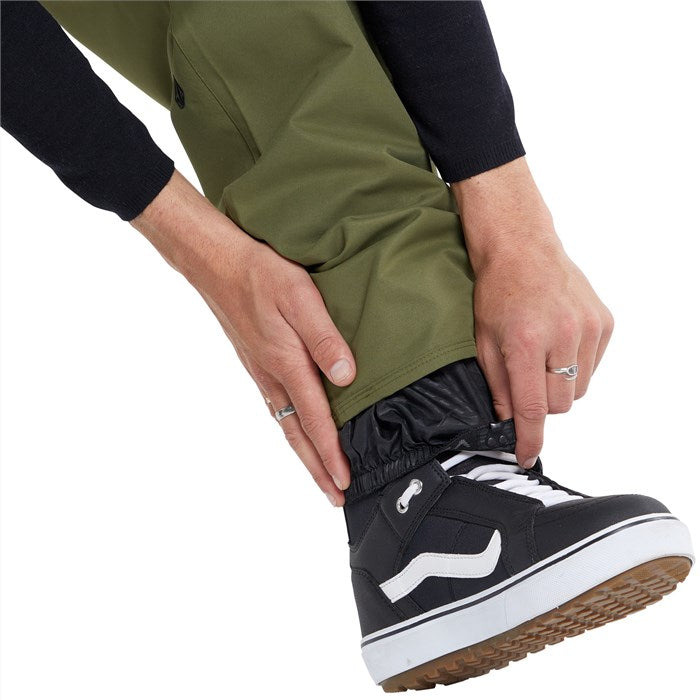 Volcom 5 Pocket Shell Pants 2024 - Olive green pants with black drawstring and zippered pockets.