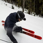 Volkl M6 Mantra Skis 2024 - A pair of red skis with black bindings and a white logo on the top sheet, viewed from above.