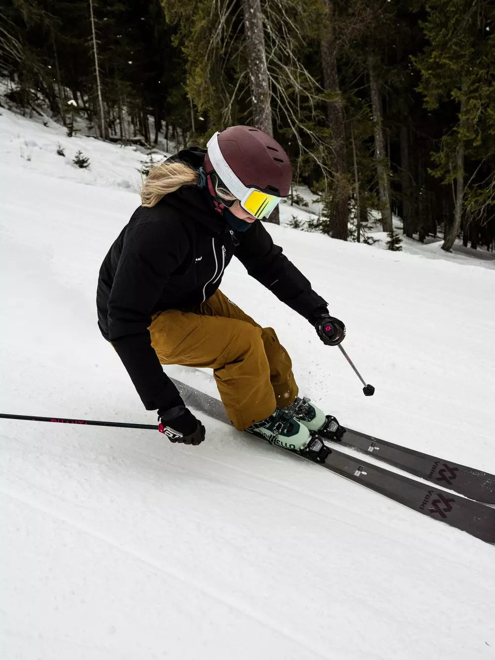 Volkl Women's Yumi 80 Skis 2024 - White skis with black bindings and a pink logo on the top of each ski.